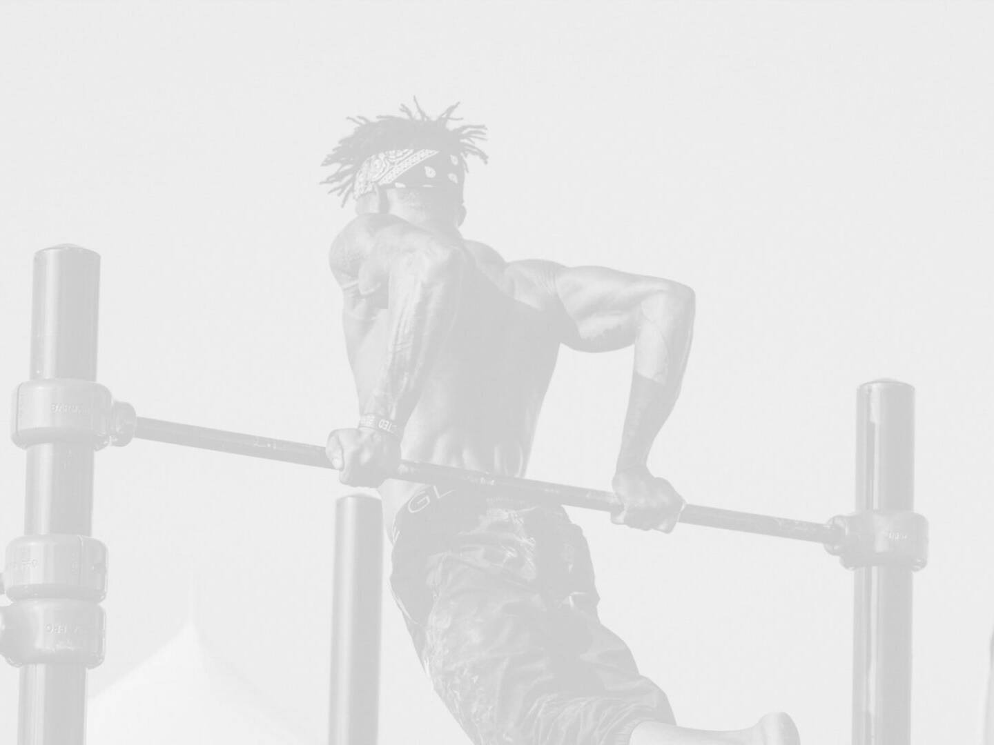 A man is doing a pull up on a bar.