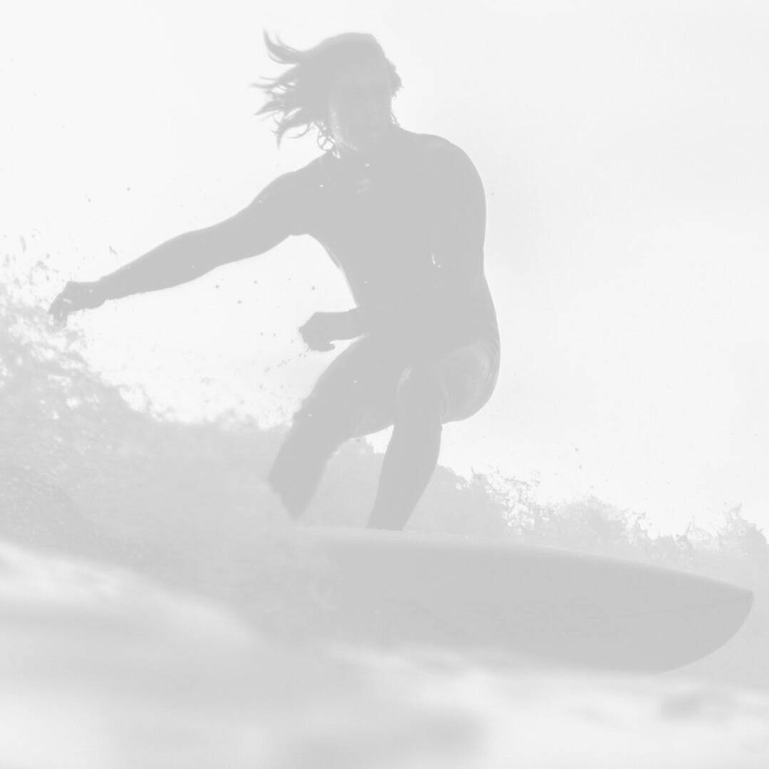 A surfer riding a wave on a surfboard.