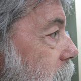 A closeup look of an elder man with white beard