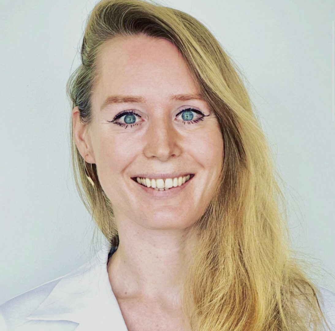Smiling woman with long blonde hair.